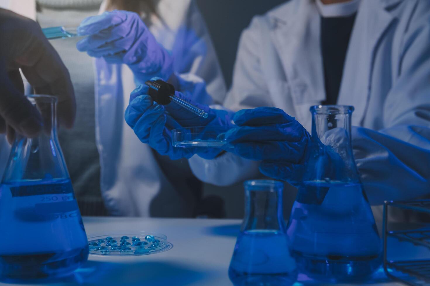 chemist,scientist hand dropping chemical liquid into test tube, science research and development concept photo