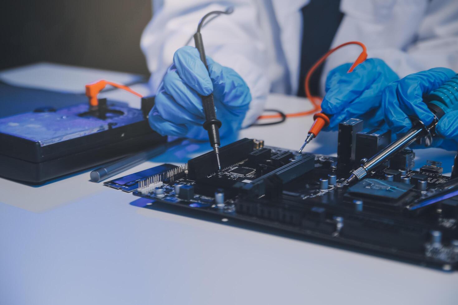 Close up of Technician measuring voltage electronic circuit board television, Service after sale fix electric equipment within insurance. photo