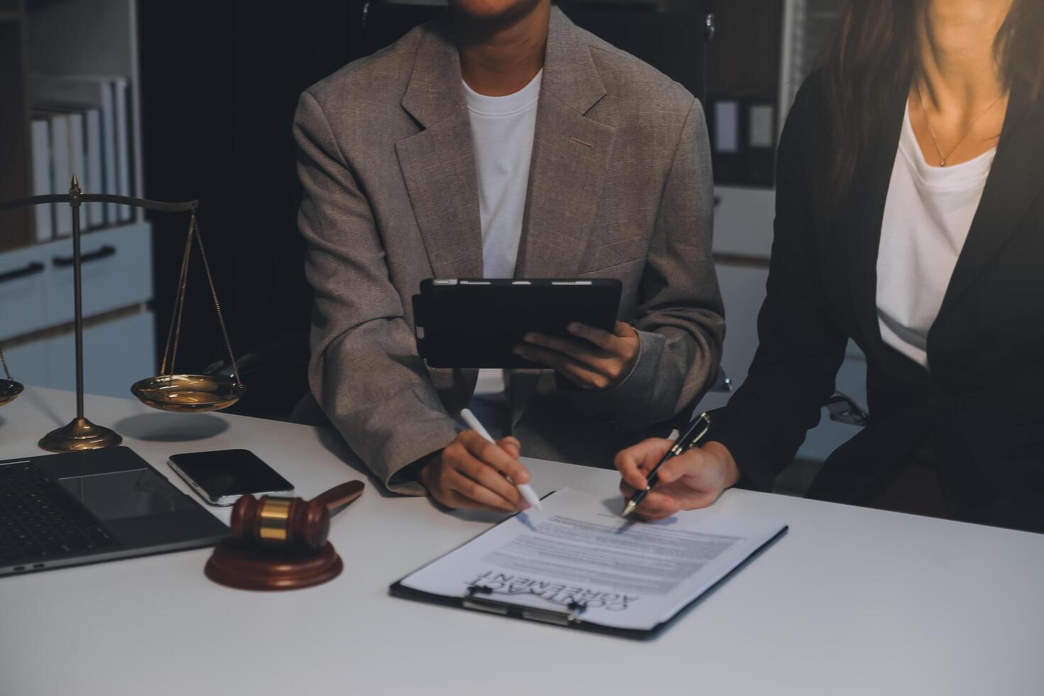 Lawyer, legal advisor, businessman brainstorming information on agreement details Business contracts in legal processing books for accuracy in contract documents. joint financial investment. photo