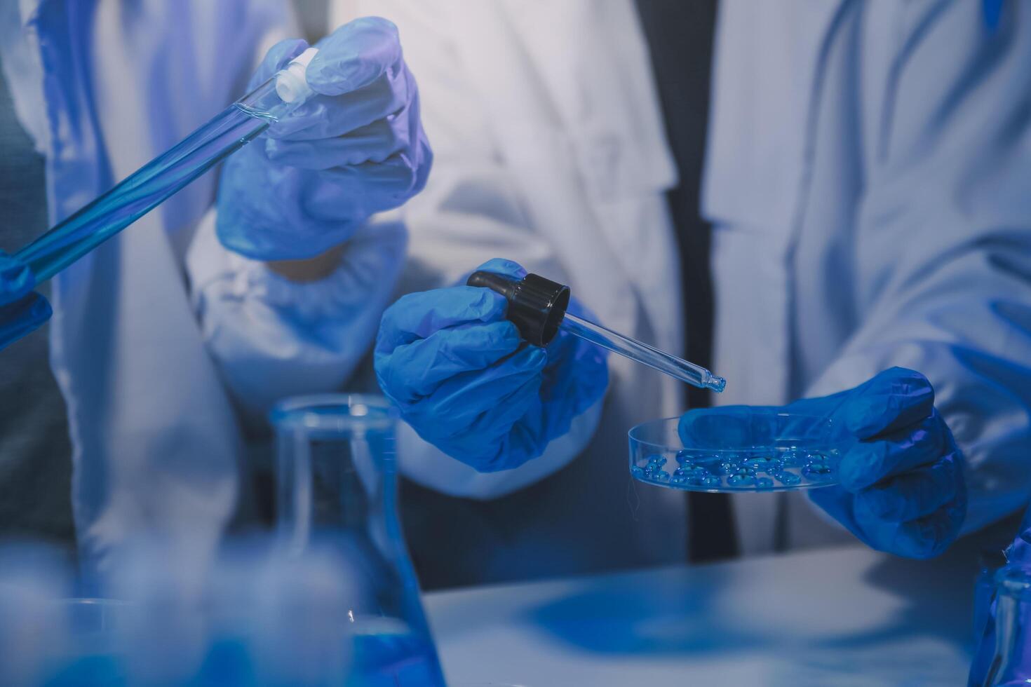 chemist,scientist hand dropping chemical liquid into test tube, science research and development concept photo