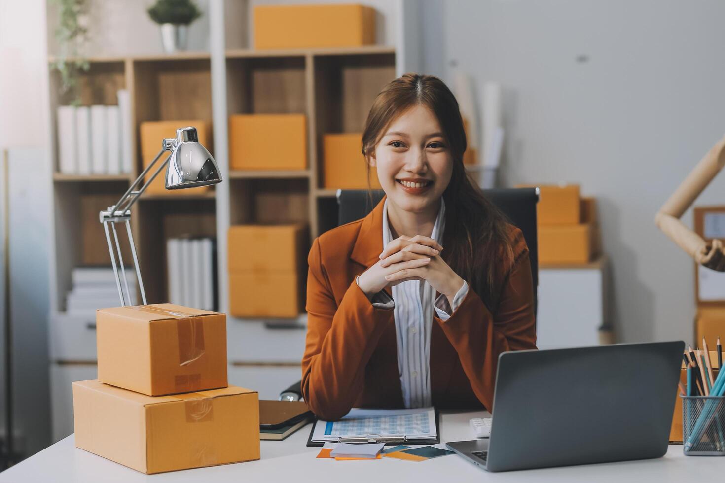 Starting Small business entrepreneur freelance,Portrait young woman working at home office, BOX,smartphone,laptop, online, marketing, packaging, delivery, SME, e-commerce concept photo