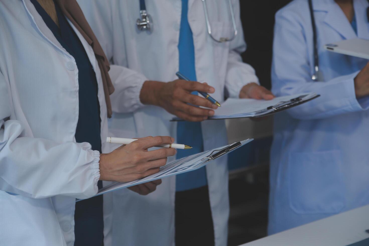 Doctors shaking hands, working together as a team at the hospital. photo