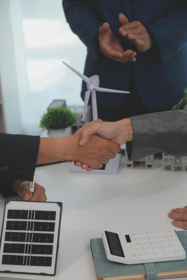 Construction workers holding helmets and vests are shaking hands. real estate concept Architect shaking hands with engineer or builder planning and successful meetings photo