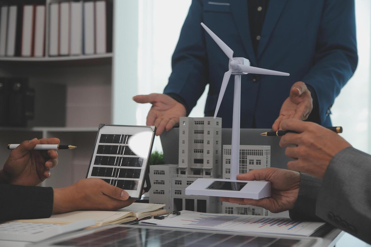 Team of architectures and businessman are discussing and brainstorming on floor plan modification for real estate sustainable investment and solar energy housing development project photo