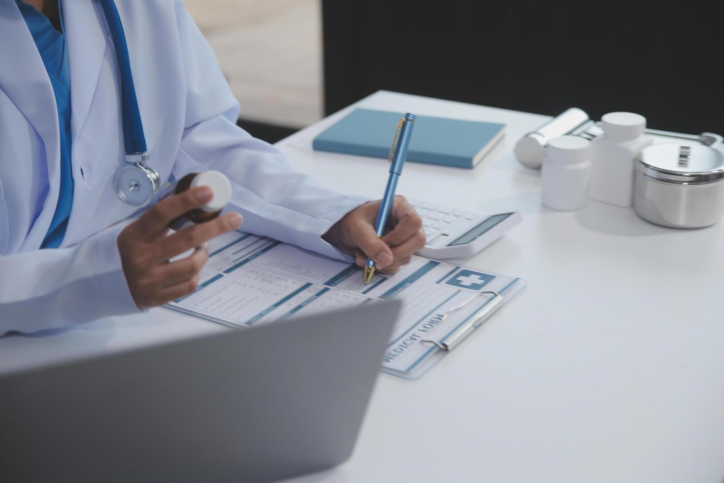 Cropped view of doctor in white coat holding bottle medication, prescribing pills to sick patient via online consultation. Family therapist recommend quality medicines. Healthcare, treatment concept photo