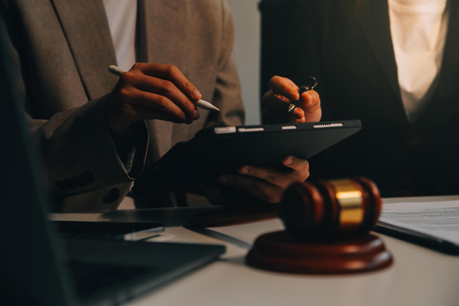 Lawyer, legal advisor, businessman brainstorming information on agreement details Business contracts in legal processing books for accuracy in contract documents. joint financial investment. photo