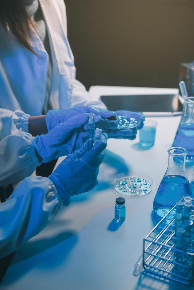 chemist,scientist hand dropping chemical liquid into test tube, science research and development concept photo