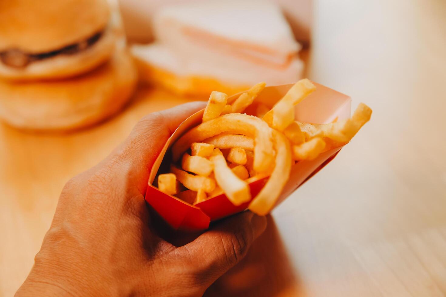 Fresh fried french fries with ketchup on wooden background photo