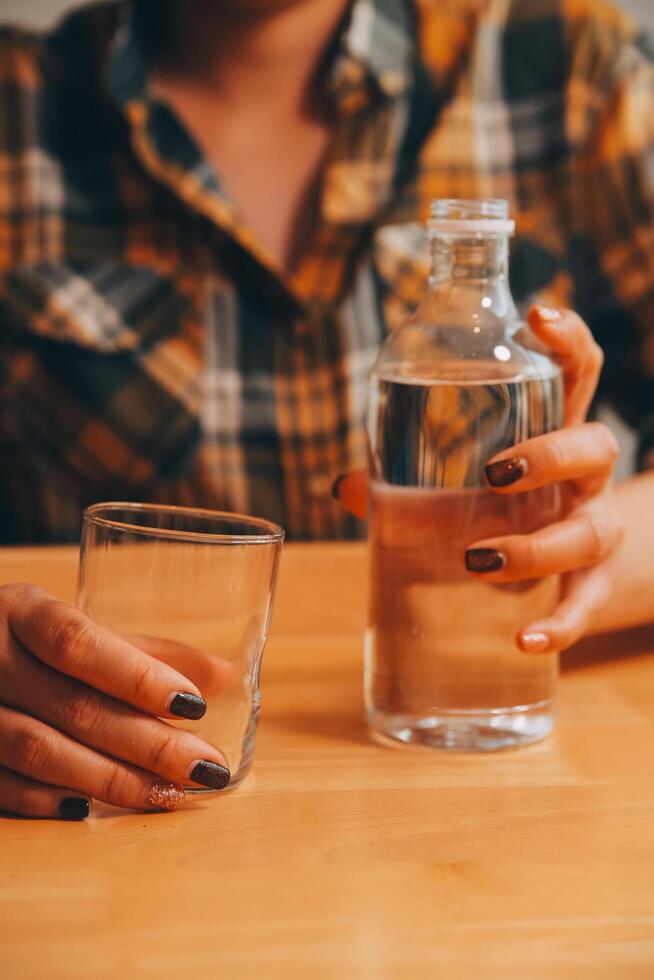 healthy beautiful young woman holding glass of water photo