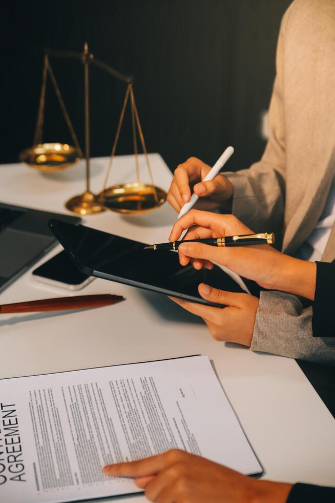 Lawyer, legal advisor, businessman brainstorming information on agreement details Business contracts in legal processing books for accuracy in contract documents. joint financial investment. photo