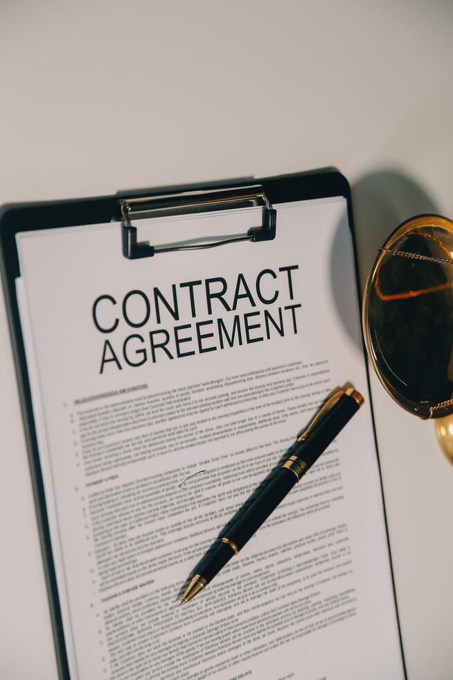 Lawyer, legal advisor, businessman brainstorming information on agreement details Business contracts in legal processing books for accuracy in contract documents. joint financial investment. photo