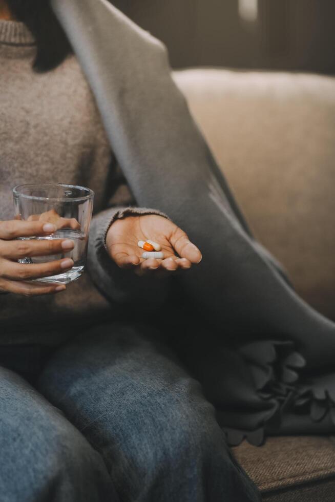 Upset woman frustrated by problem with work or relationships, sitting on couch, embracing knees, covered face in hand, feeling despair and anxiety, loneliness, having psychological trouble photo