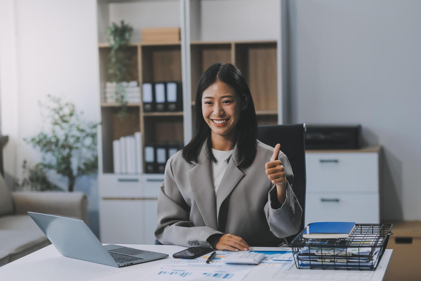 Beautiful Asian girl celebrate with laptop, success happy pose. E-commerce, university education, internet technology, or startup small business concept. Modern office or living room with copy space photo