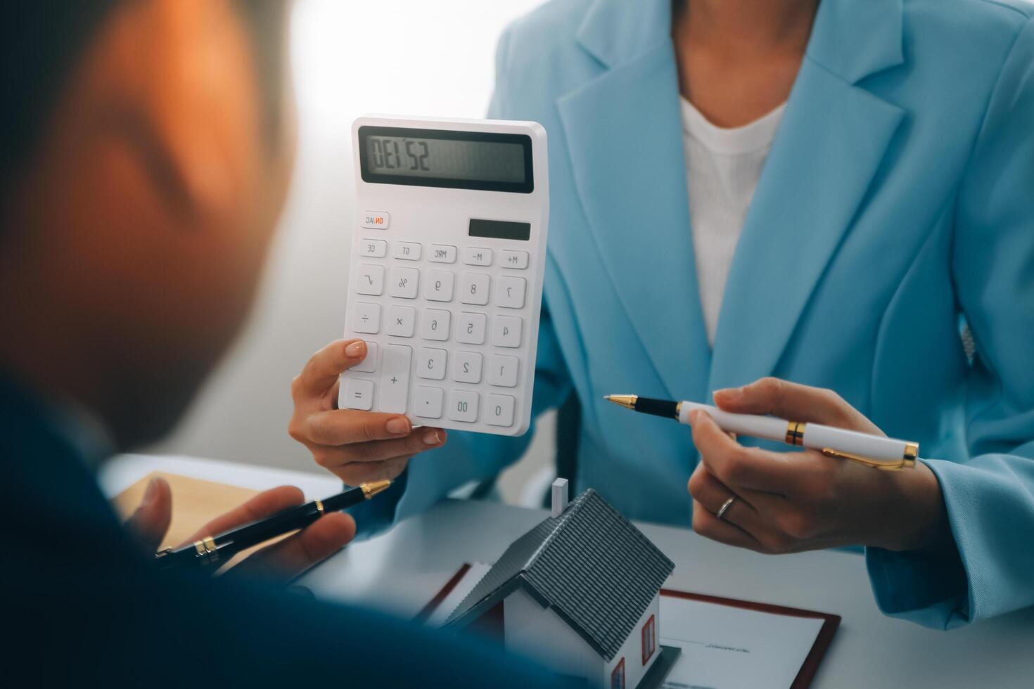 Real estate agent talked about the terms of the home purchase agreement and asked the customer to sign the documents to make the contract legally, Home sales and home insurance concept. photo