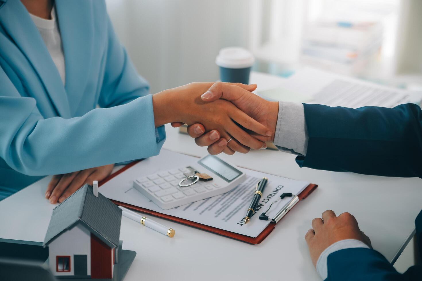 Real estate agent talked about the terms of the home purchase agreement and asked the customer to sign the documents to make the contract legally, Home sales and home insurance concept. photo