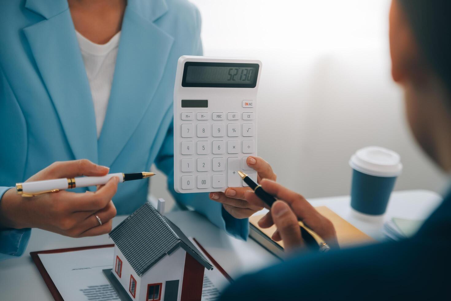 Real estate agent talked about the terms of the home purchase agreement and asked the customer to sign the documents to make the contract legally, Home sales and home insurance concept. photo