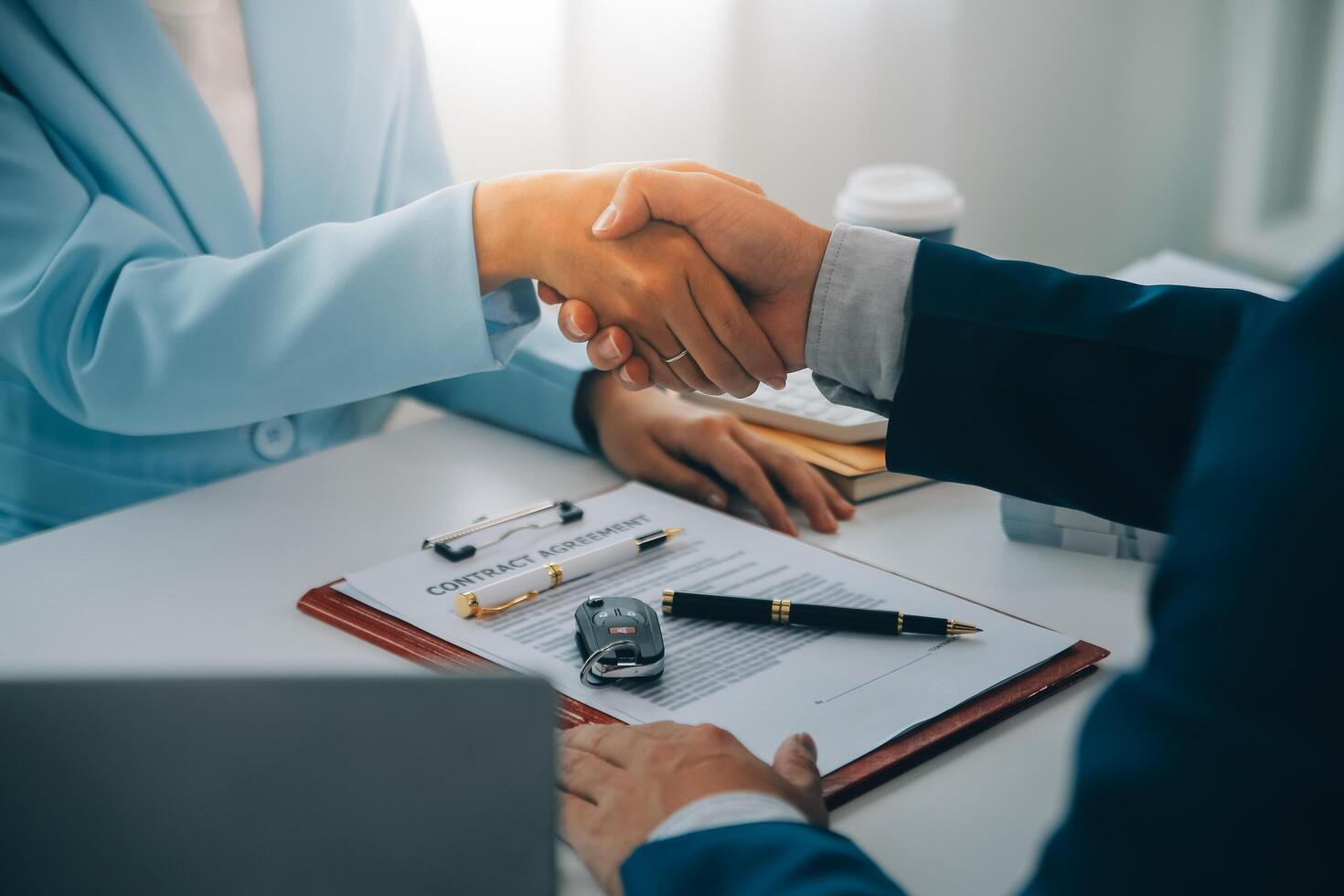 Insurance officers hand over the car keys after the tenant. have signed an auto insurance document or a lease or agreement document Buying or selling a new or used car with a car photo