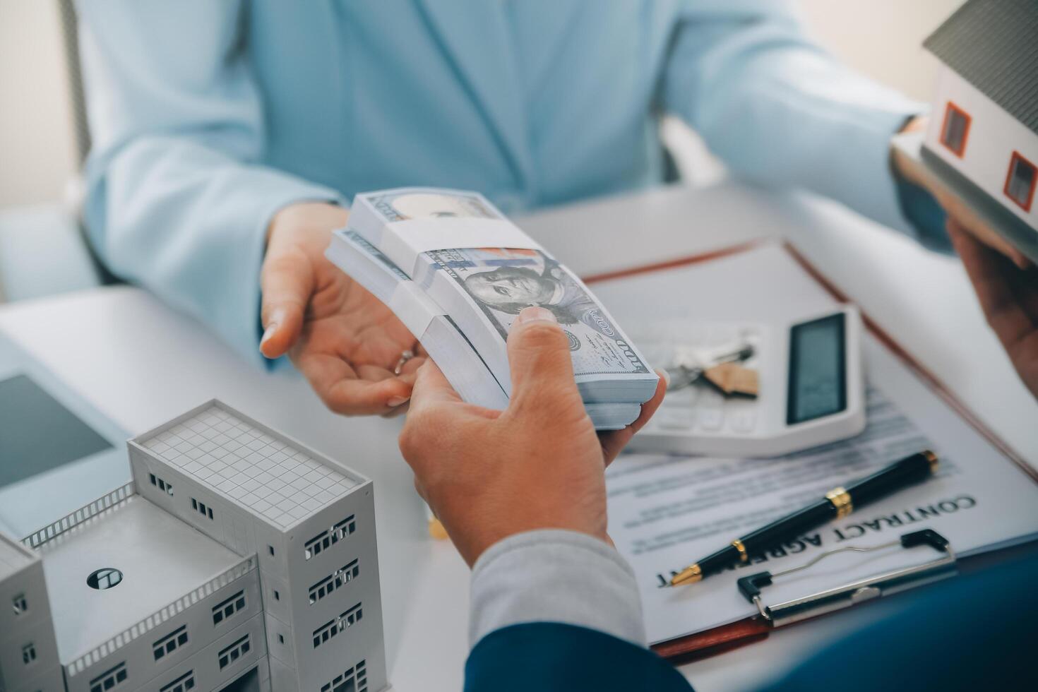 Real estate agent talked about the terms of the home purchase agreement and asked the customer to sign the documents to make the contract legally, Home sales and home insurance concept. photo
