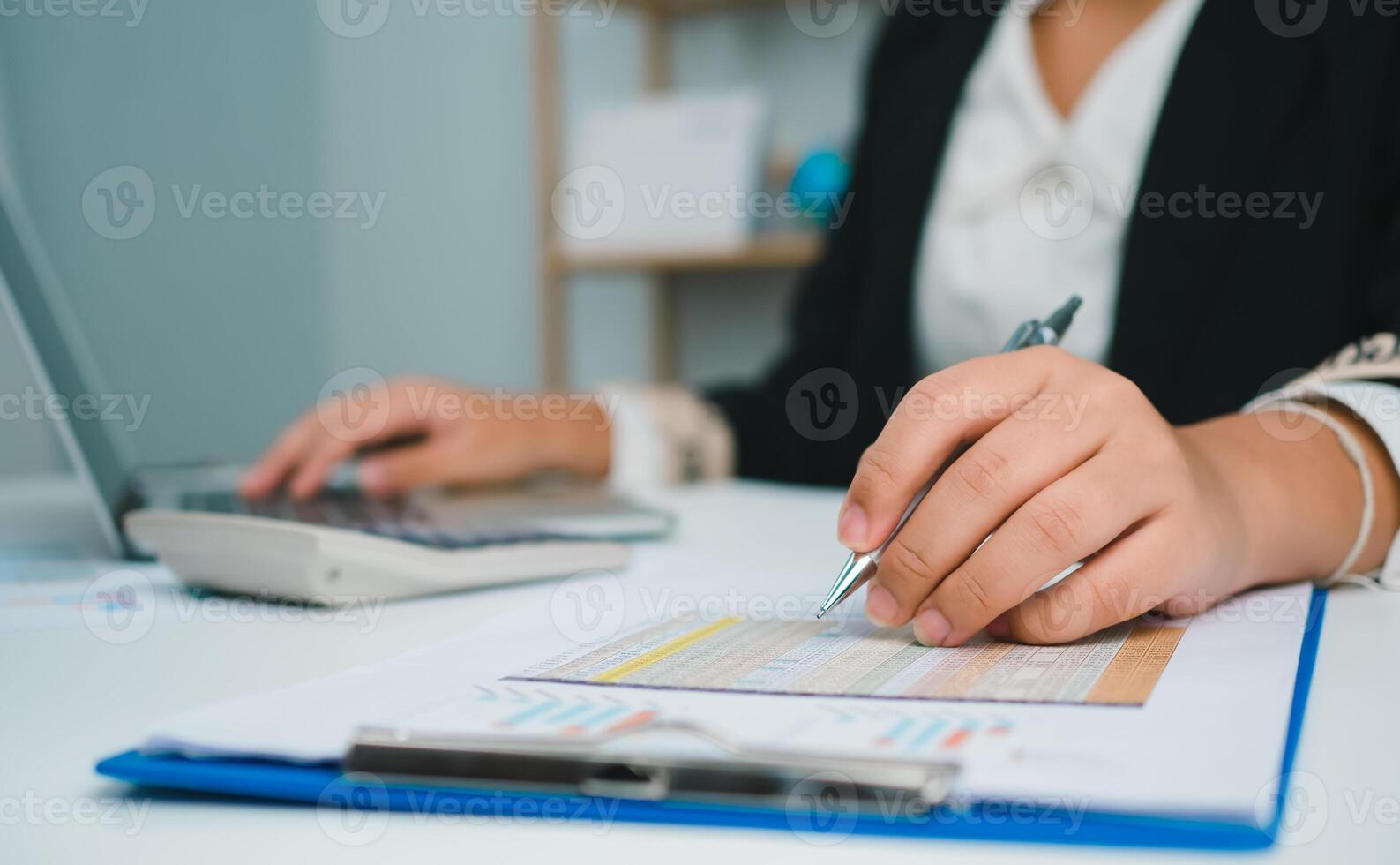 Business woman people use computers and paper documents to analyze business and manage corporate information. Business analysis with charts, indicators, and KPIs to improve organizational performance. photo