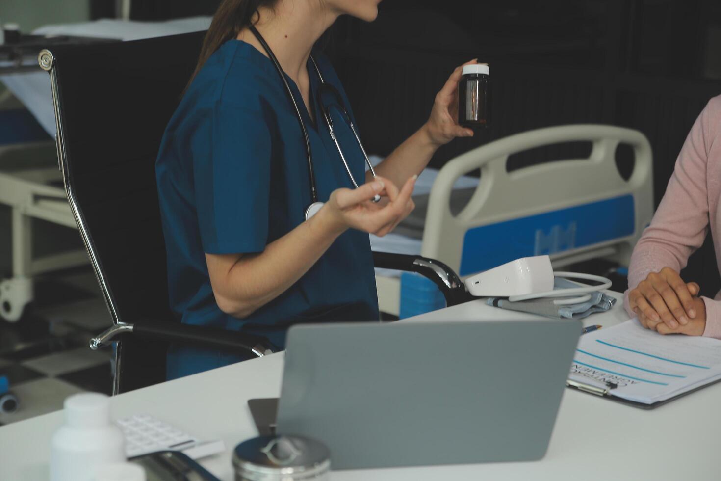 Doctor and patient discussing something while sitting at the table . Medicine and health care concept. Doctor and patient photo