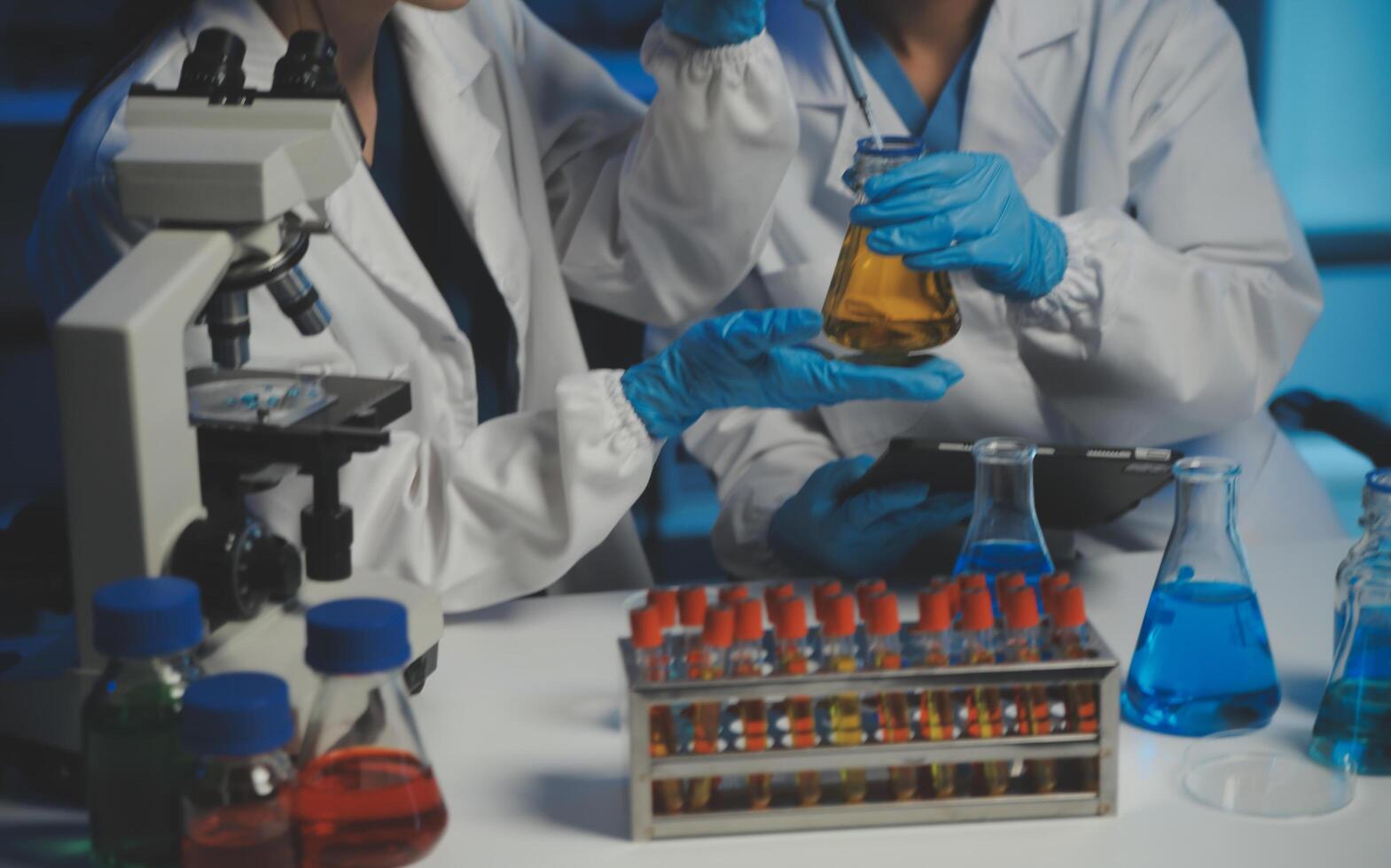 professional chemist woman laboratory using scientific microscope for science research, chemistry scientist with microbiology medicals equipment technology to working with medicine biology experiment photo