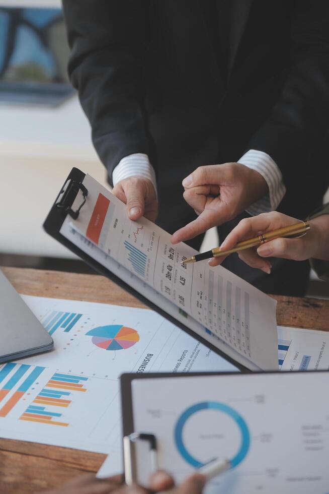 Co working conference, Business team meeting present, investor colleagues discussing new plan financial graph data on office table with laptop and digital tablet, Finance, accounting, investment. photo