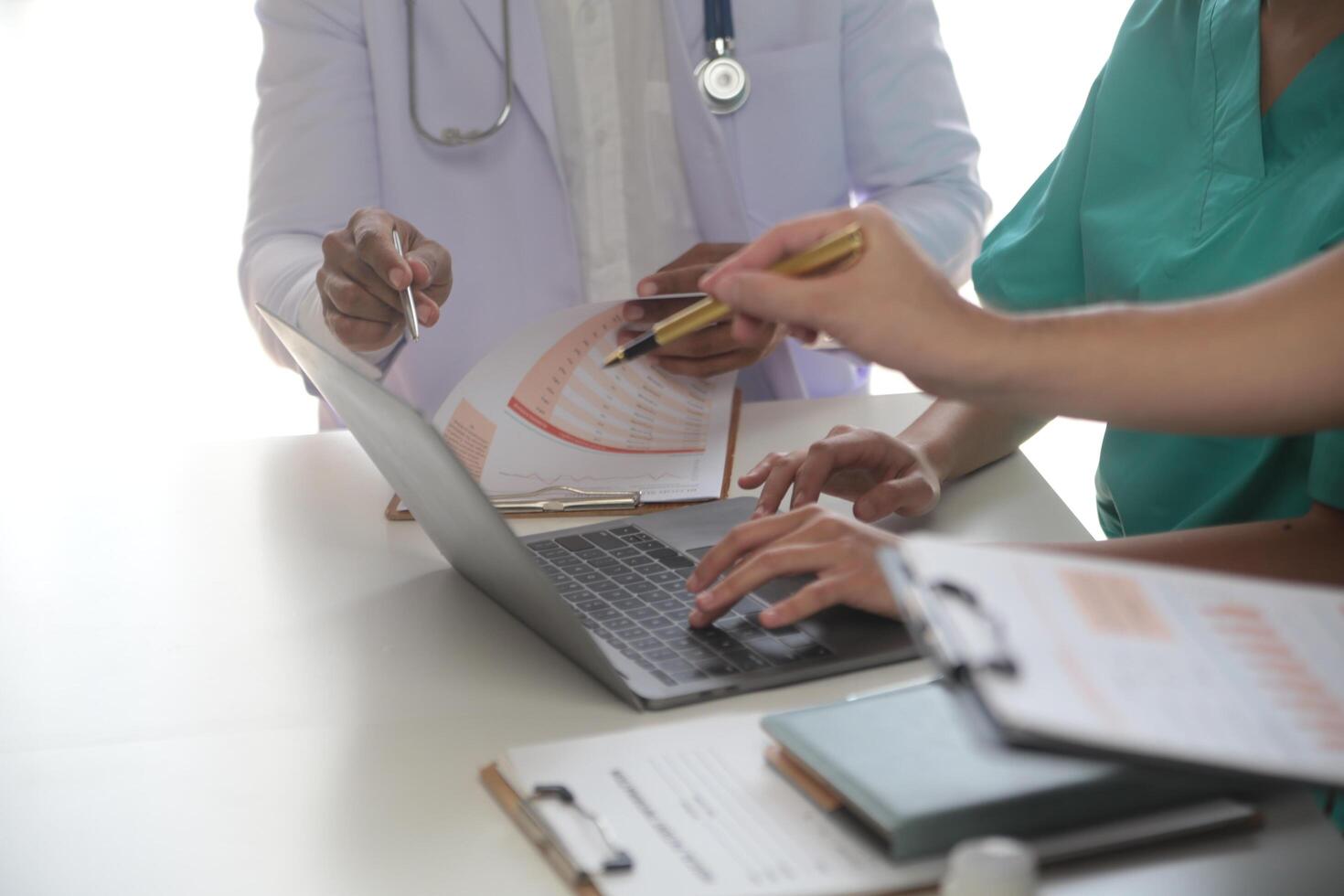 Medical Team Meeting Around Table In Modern Hospital photo