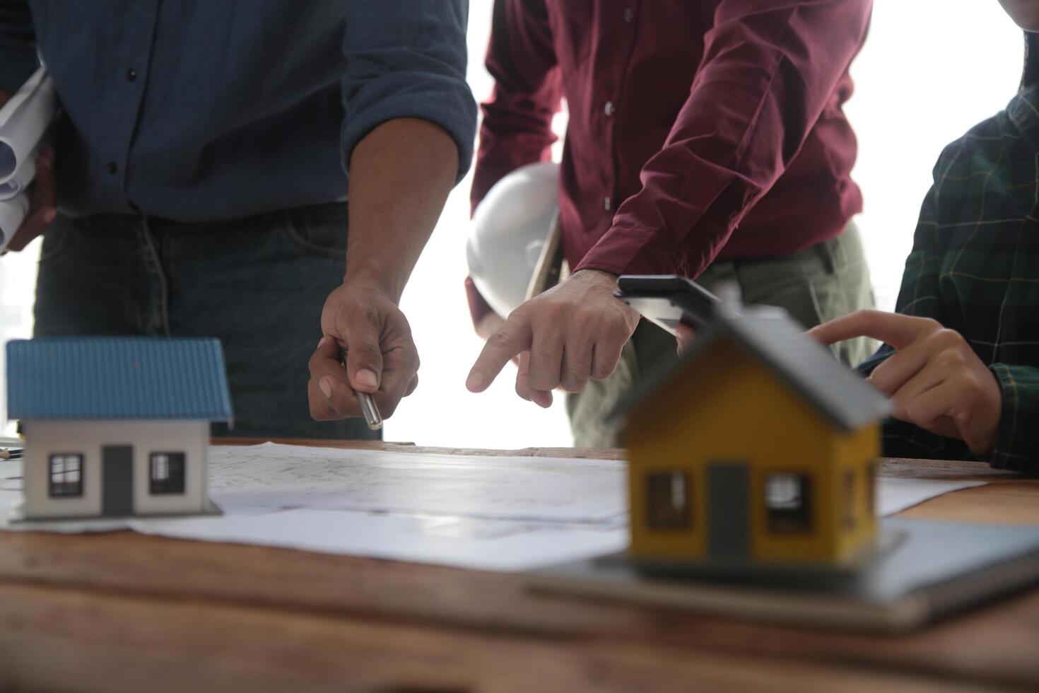 Diverse Team of Specialists Use Laptop on Construction Site. Real Estate Building Project with Engineer Investor and Businessman Checking Area, working on Civil Engineering, Discussing Strategy Plan photo