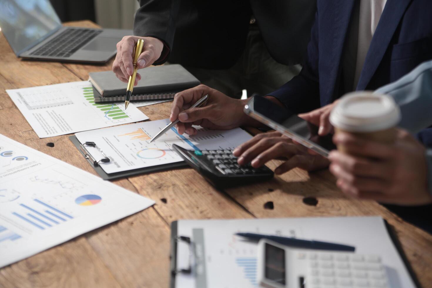 Business team meeting working with new startup project, discussion and analysis data the charts and graphs. Digital tablet, calculator, laptop computer using, Business finance and accounting concept. photo