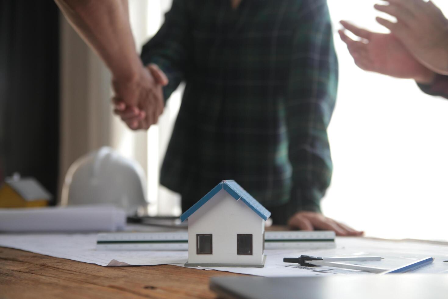 Engineer and contractor join hands after signing contract,They are having a modern building project together. successful cooperation team concept photo