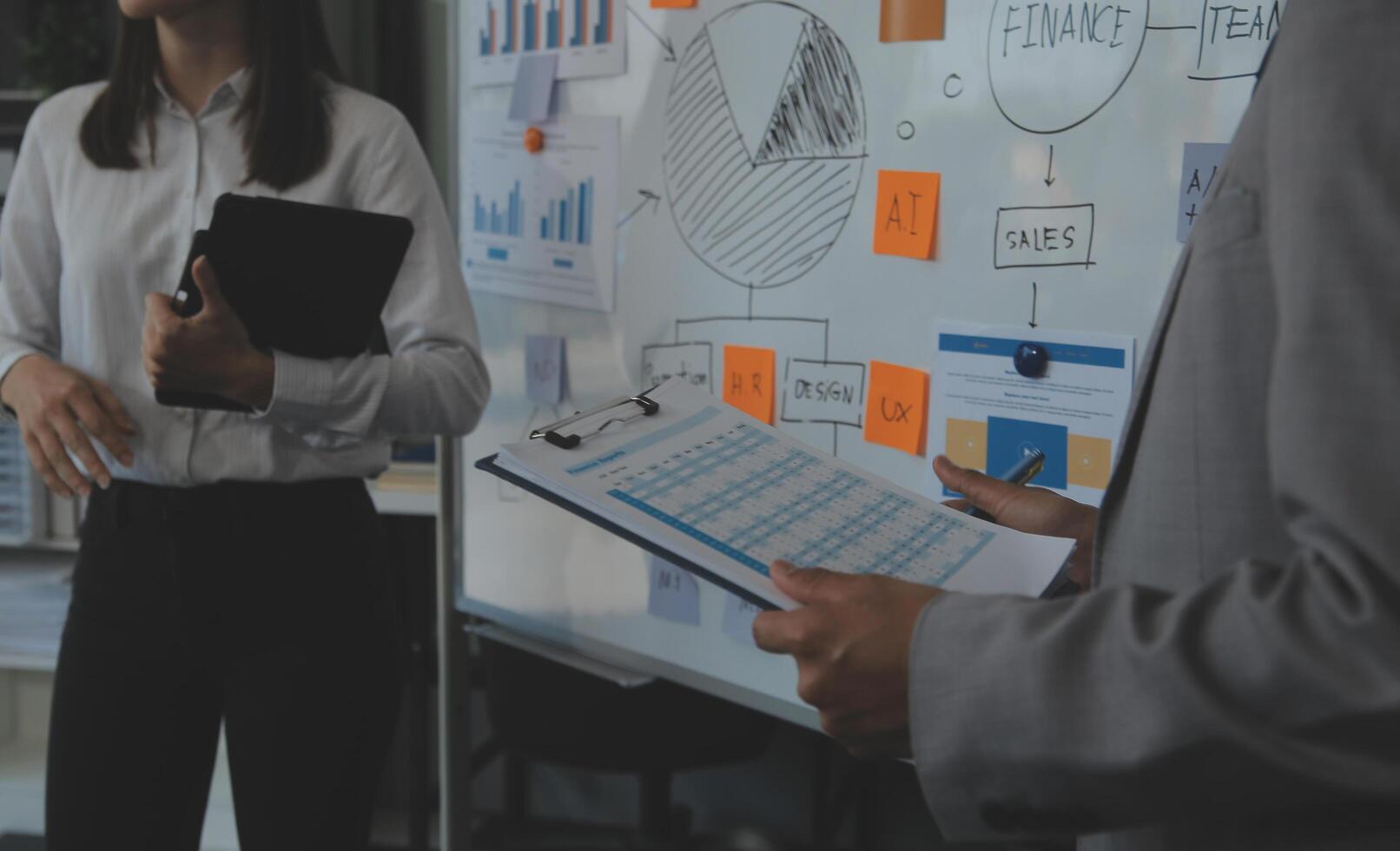 Financial analysts analyze business financial reports on a digital tablet planning investment project during a discussion at a meeting of corporate showing the results of their successful teamwork. photo