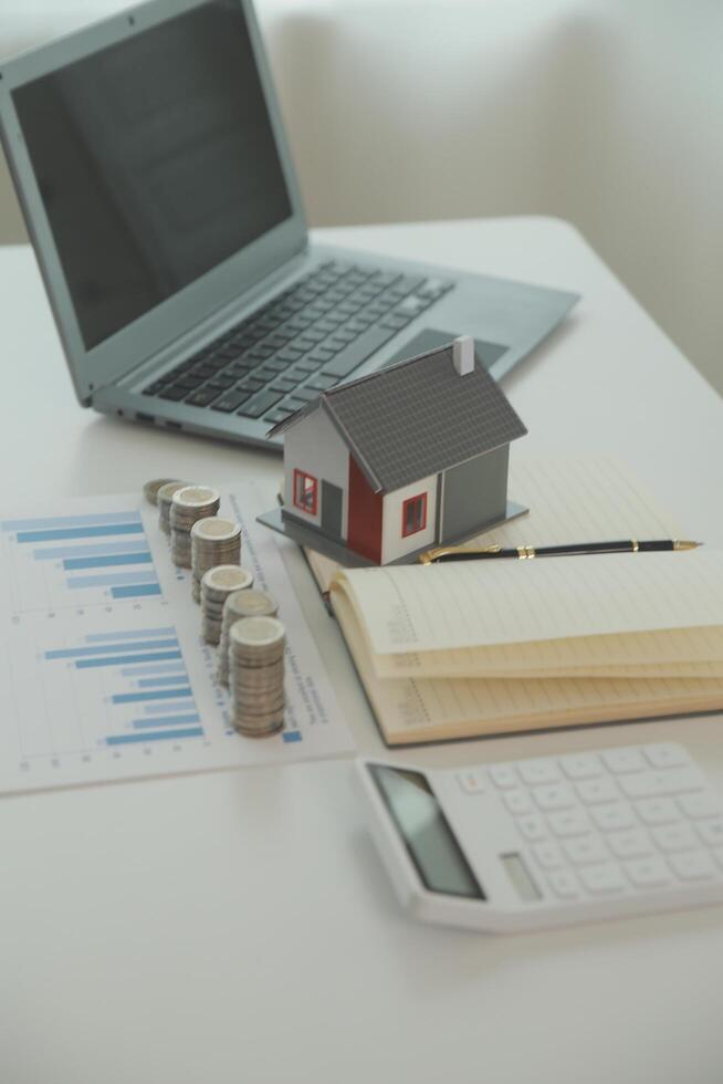 Saving money wealth concept, asian young business woman hand write management budget for saving cost, cash finance planning to spend enough money on her income for save money, payment tax, investing. photo