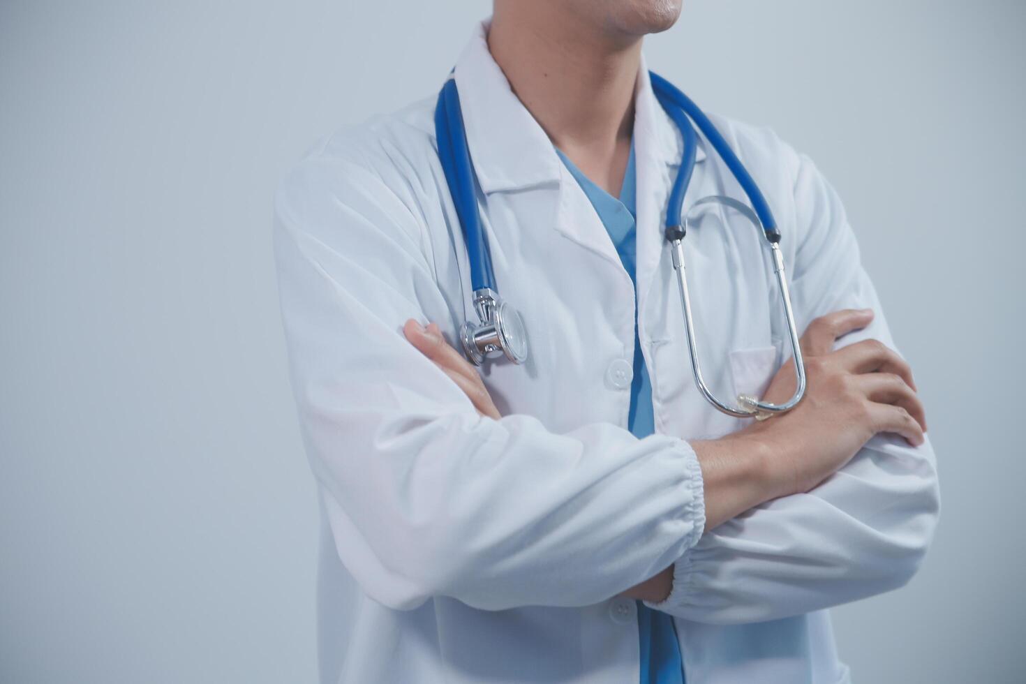 Mature male doctor with tablet pc is giving presentation. Blurred background indoors. photo