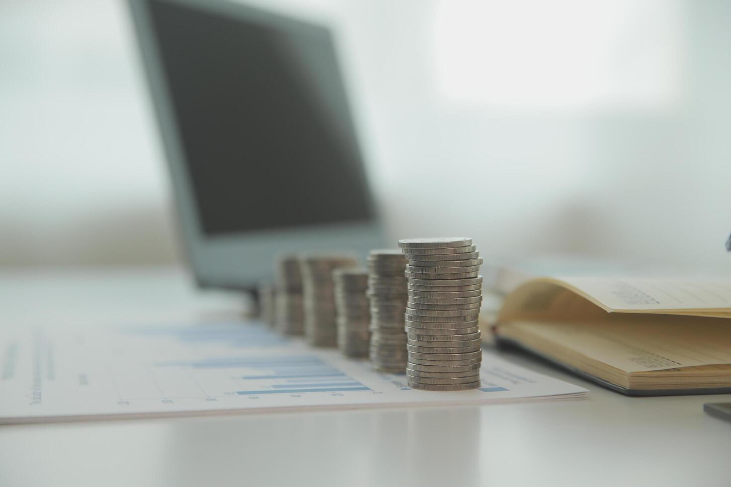 Saving money wealth concept, asian young business woman hand write management budget for saving cost, cash finance planning to spend enough money on her income for save money, payment tax, investing. photo