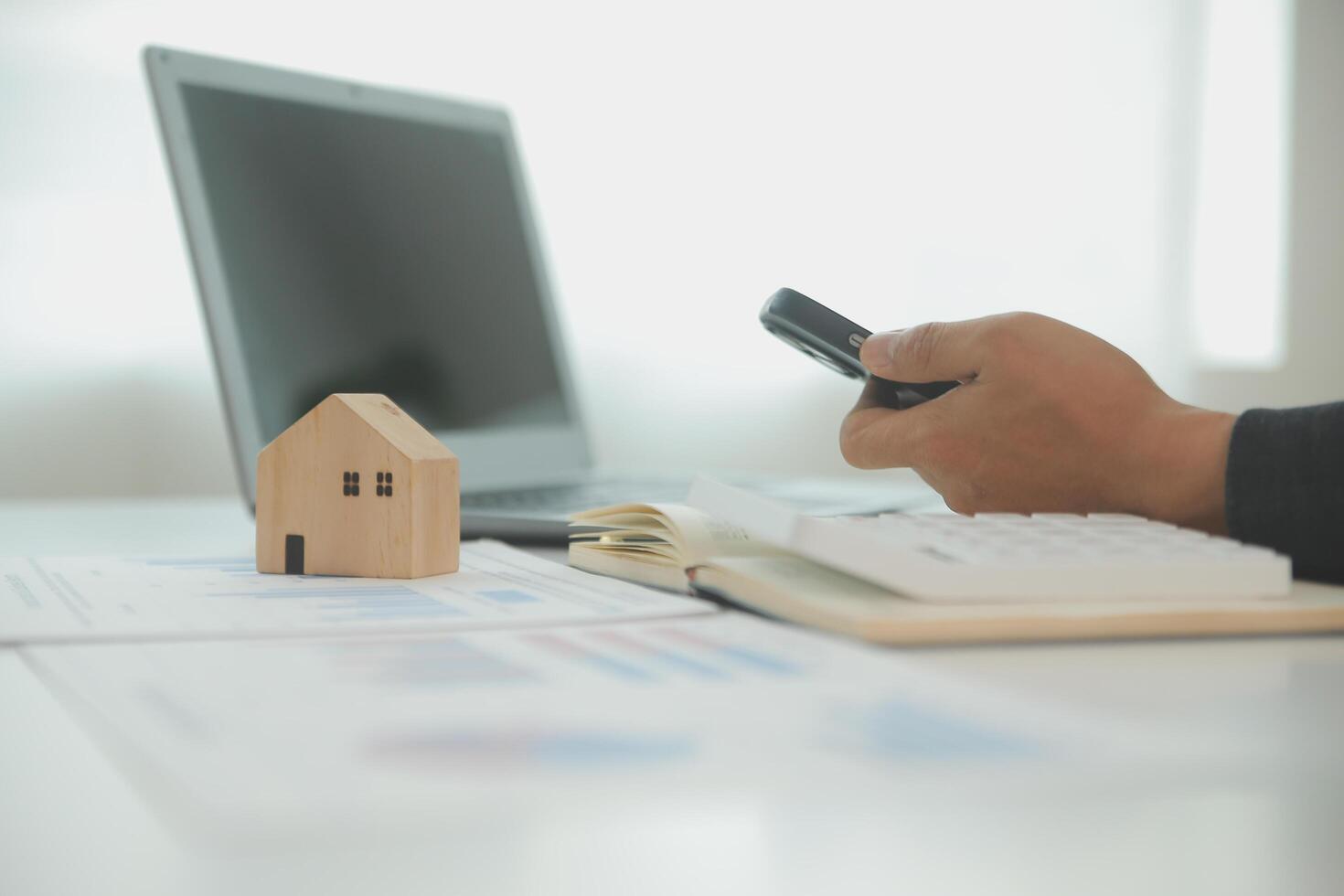 Businessmen holding pens, signing home titles with insurance, care about real estate services and the idea of real estate agents offering interest in installments to their customers. photo