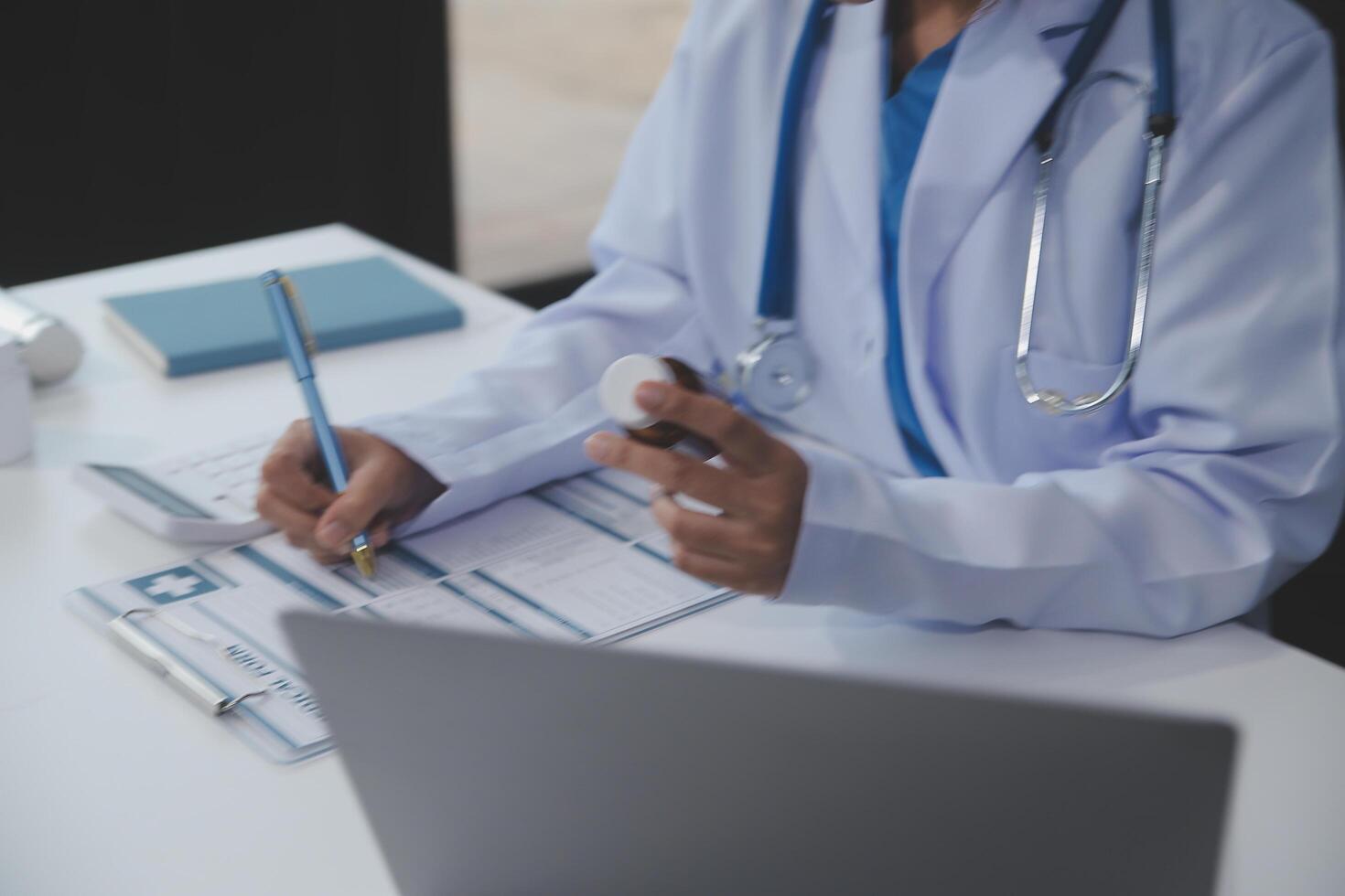 Cropped view of doctor in white coat holding bottle medication, prescribing pills to sick patient via online consultation. Family therapist recommend quality medicines. Healthcare, treatment concept photo