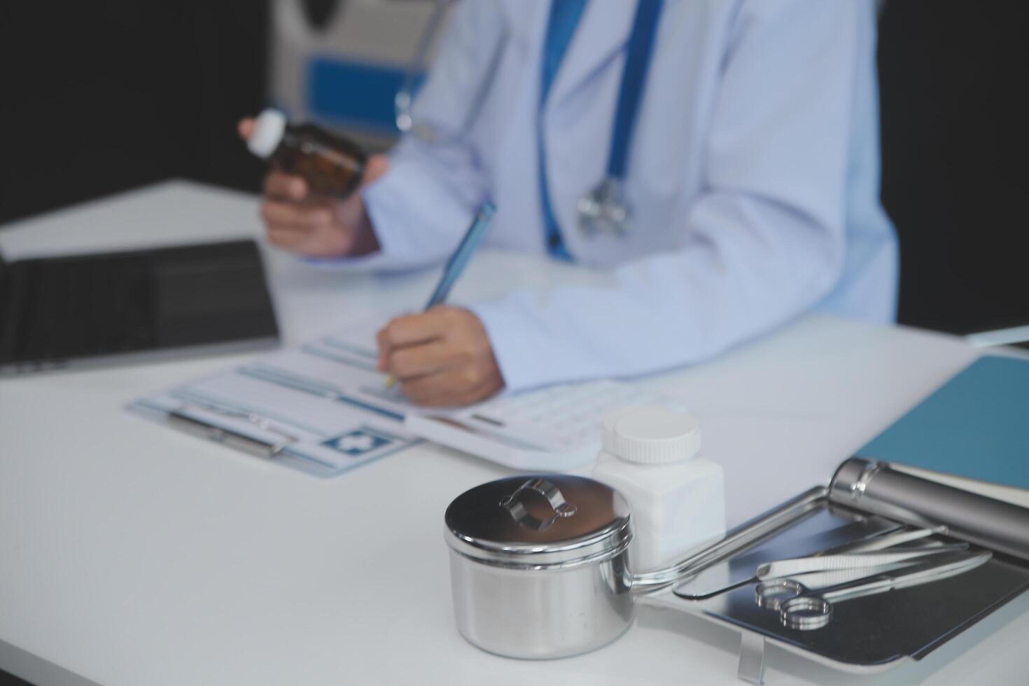 Cropped view of doctor in white coat holding bottle medication, prescribing pills to sick patient via online consultation. Family therapist recommend quality medicines. Healthcare, treatment concept photo