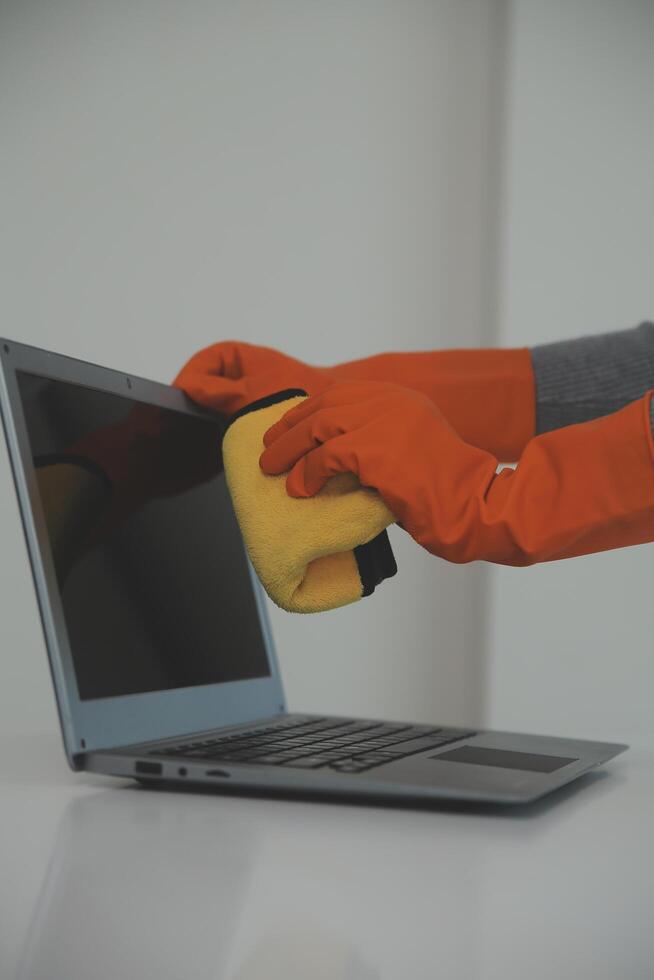 Woman cleaning table using rag and diffuser at home. photo