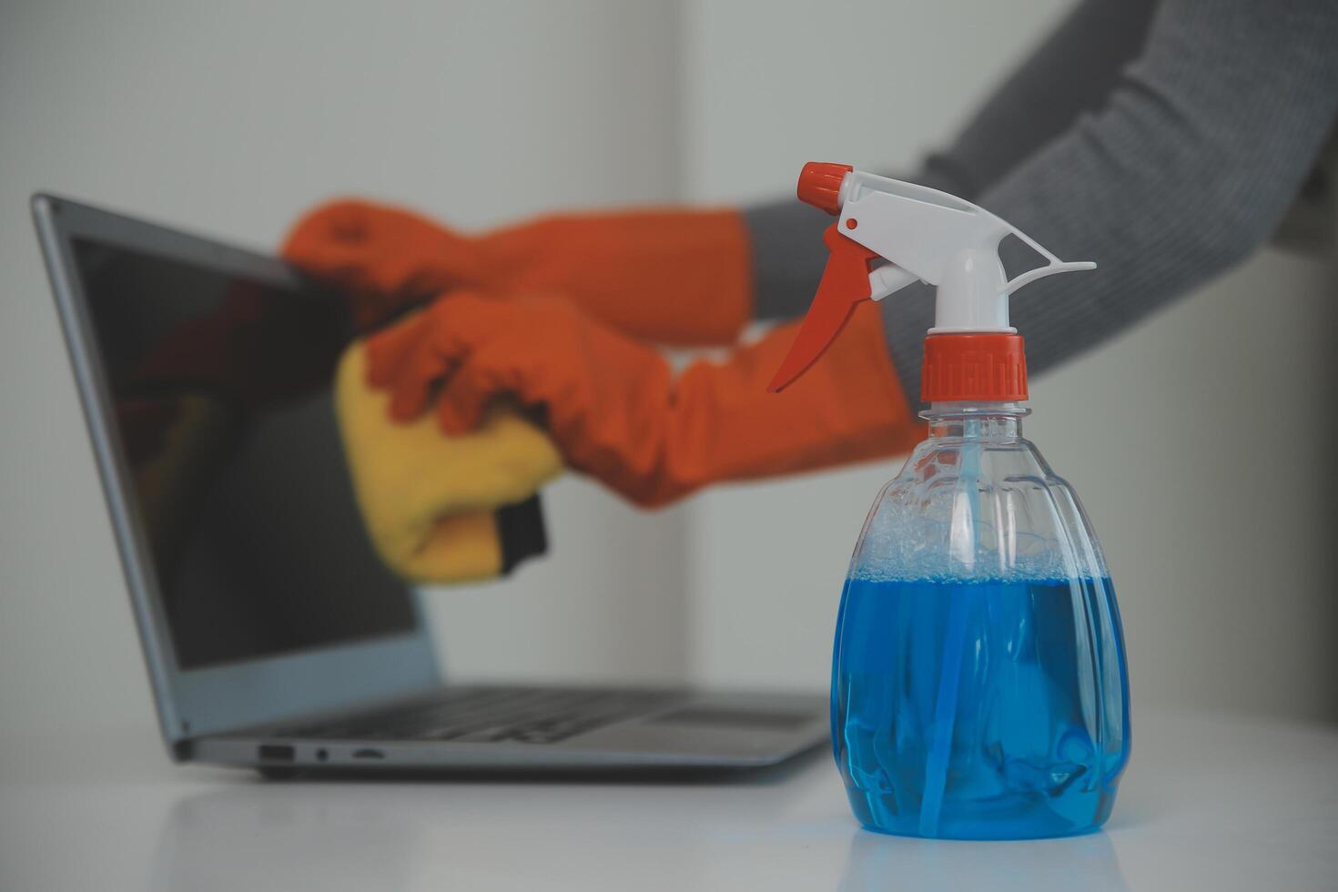 Woman cleaning table using rag and diffuser at home. photo