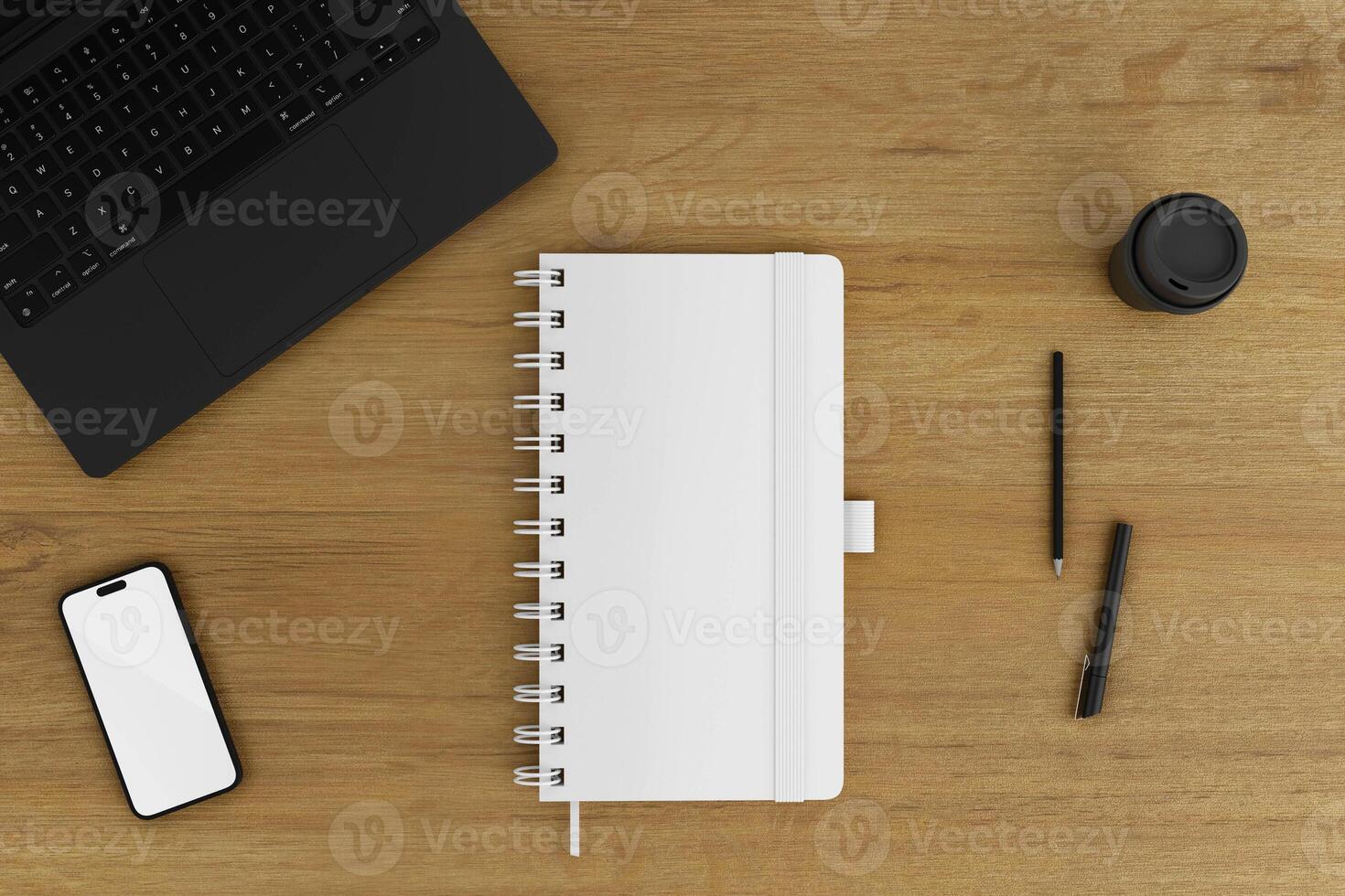 notebook and phone on top of a wooden table photo