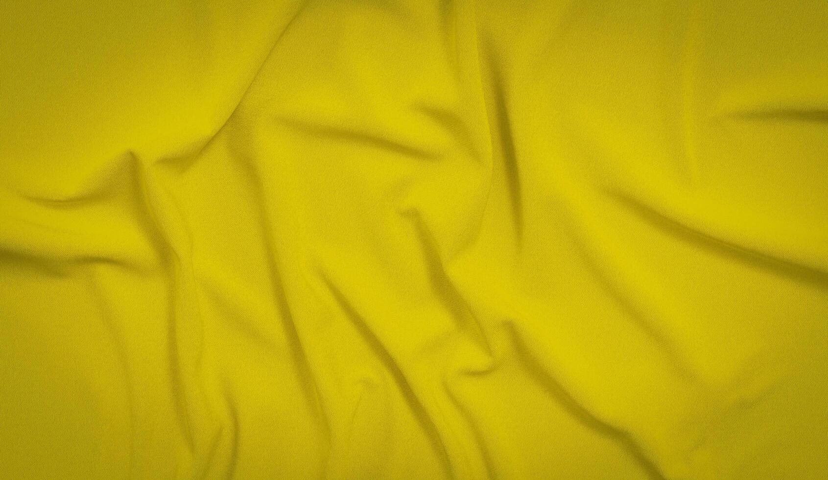 Yellow wave silk fabric background. Yellow background texture photo