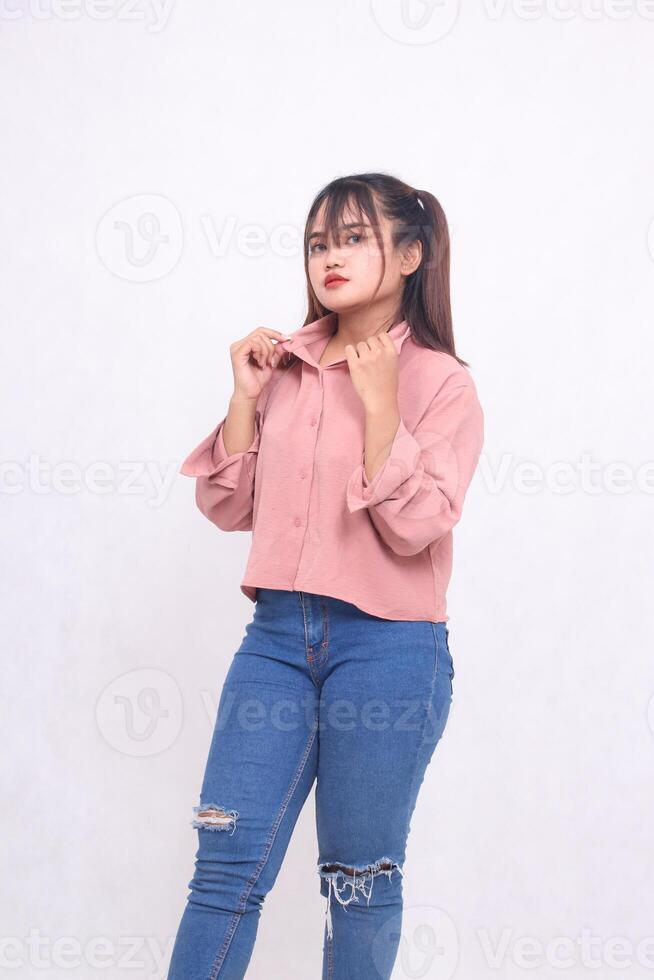 Young beautiful cool Asian woman holding collar and looking at camera with angry face and beautiful girl stylish as working, used advertising on white background photo