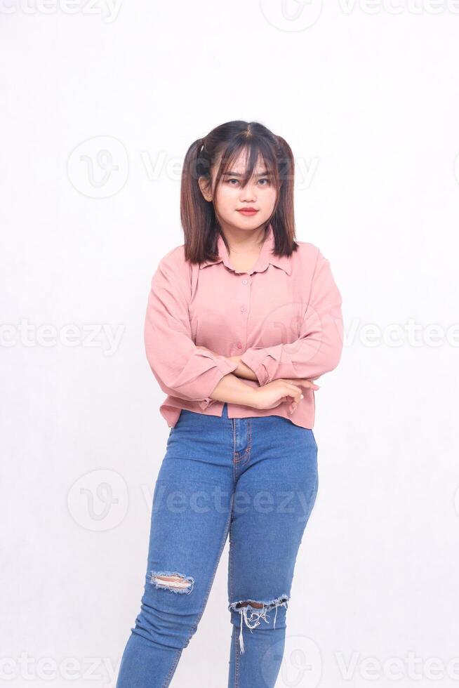 Beautiful cool young Asian woman with her arms crossed and looking at the camera with an innocent face and beautiful stylish girl acting like working, used for advertising on white backed background photo