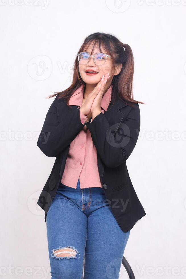 Beautiful elegant Asian Indonesian girl in a casual suit working professionally in an office holding hands kissing cheerfully on a white background for promotions, advertisements, banners, billboards photo