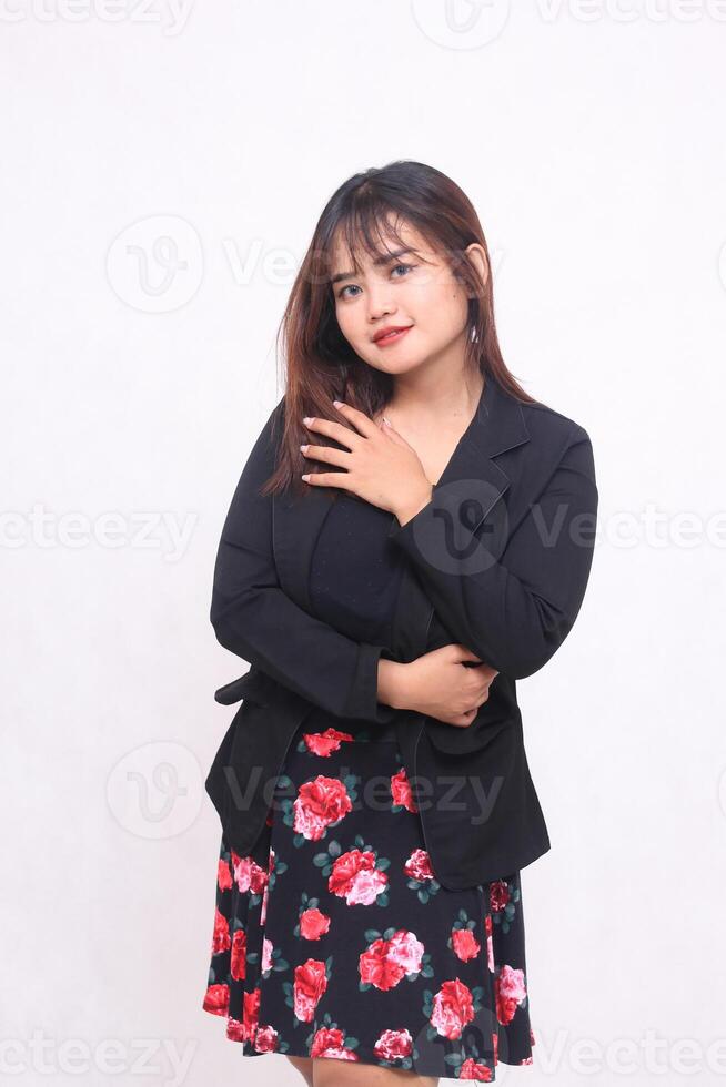 Beautiful Asian Indonesian girl in a casual professional office skirt, happy, right hand, middle, upper arms on a white background for promotion, advertising, banner photo