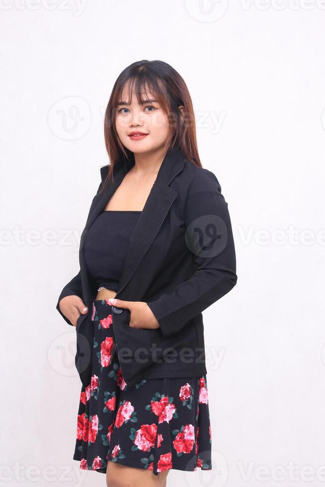 Beautiful Asian Indonesian girl in a casual professional office skirt, right hand in pocket out on a white background for promotions, advertisements, banners, billboards photo