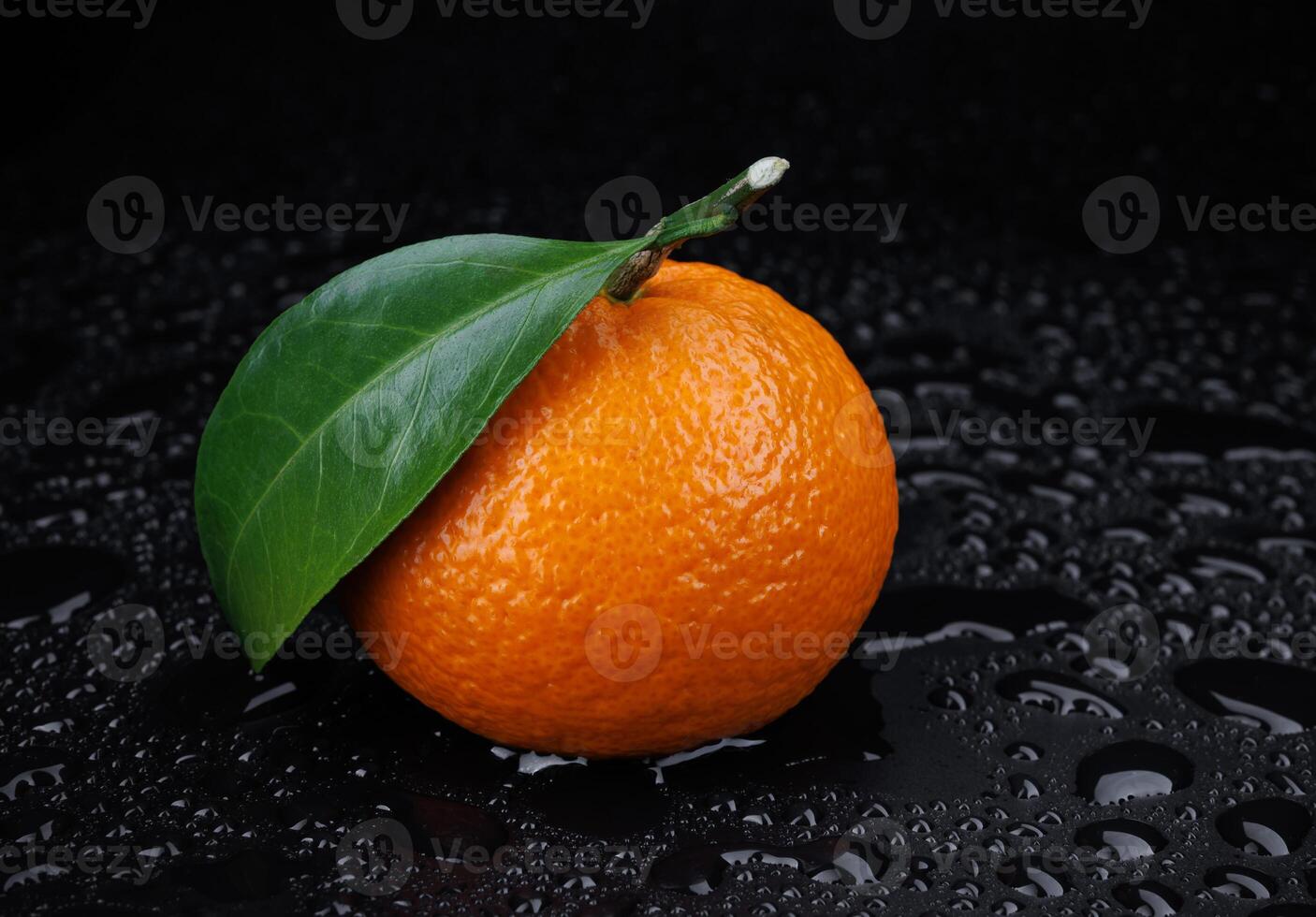maduro jugoso Mandarina en un negro antecedentes con agua gotas. foto