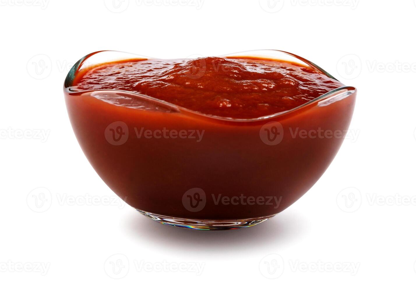 Ketchup in a glass cup isolated on a white background. Tomato sauce . photo