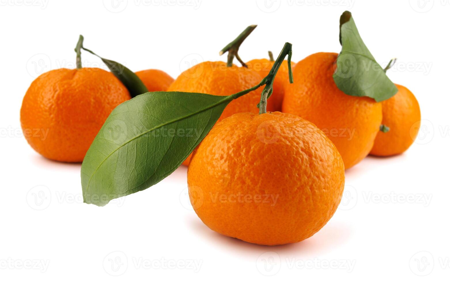 Several ripe tangerines isolated on a white background. Organic tangerine with green leaf. Mandarin. photo