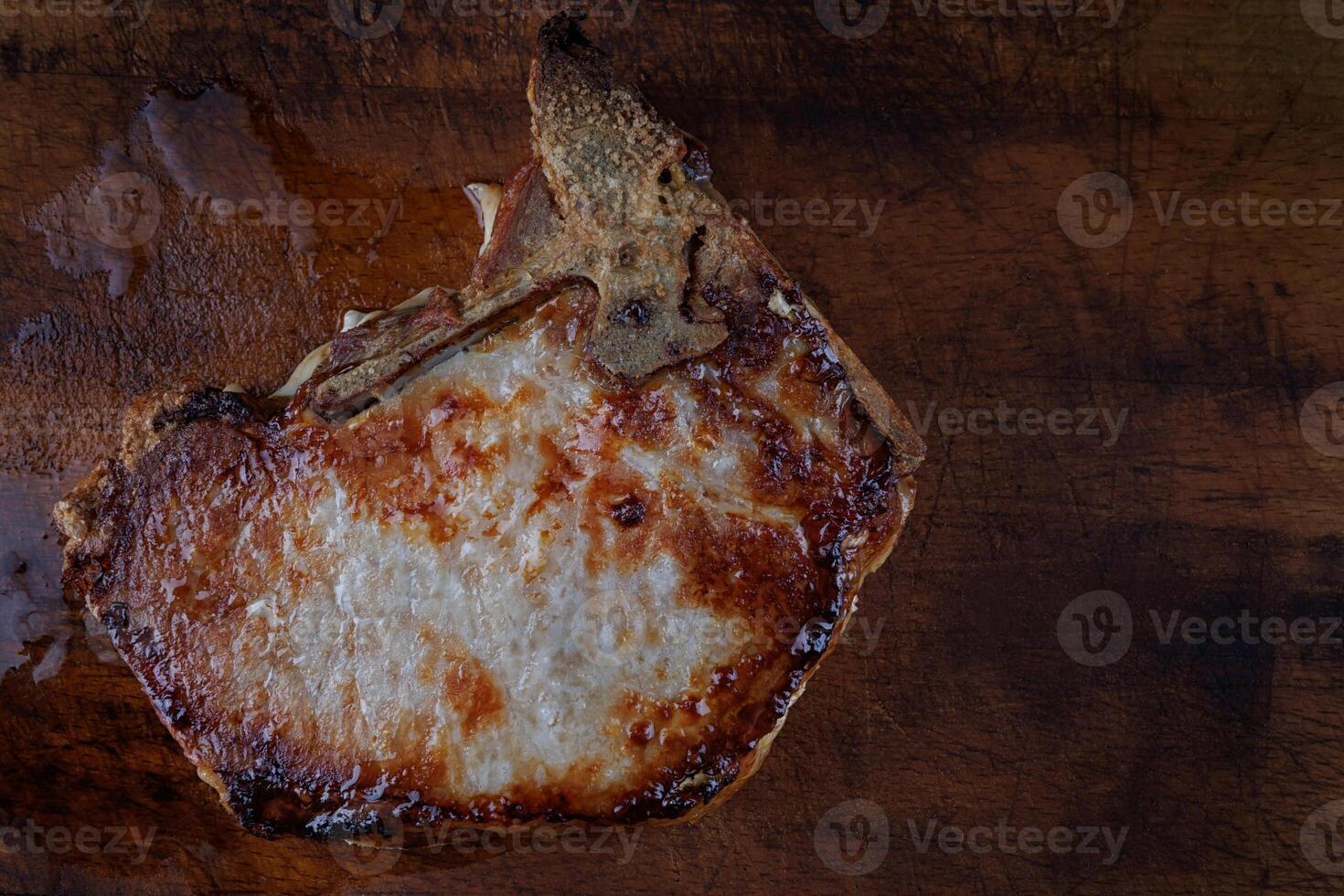 Roasted pork entrecote on a wooden cutting board. Grilled pork entrecote. Pork steak. photo